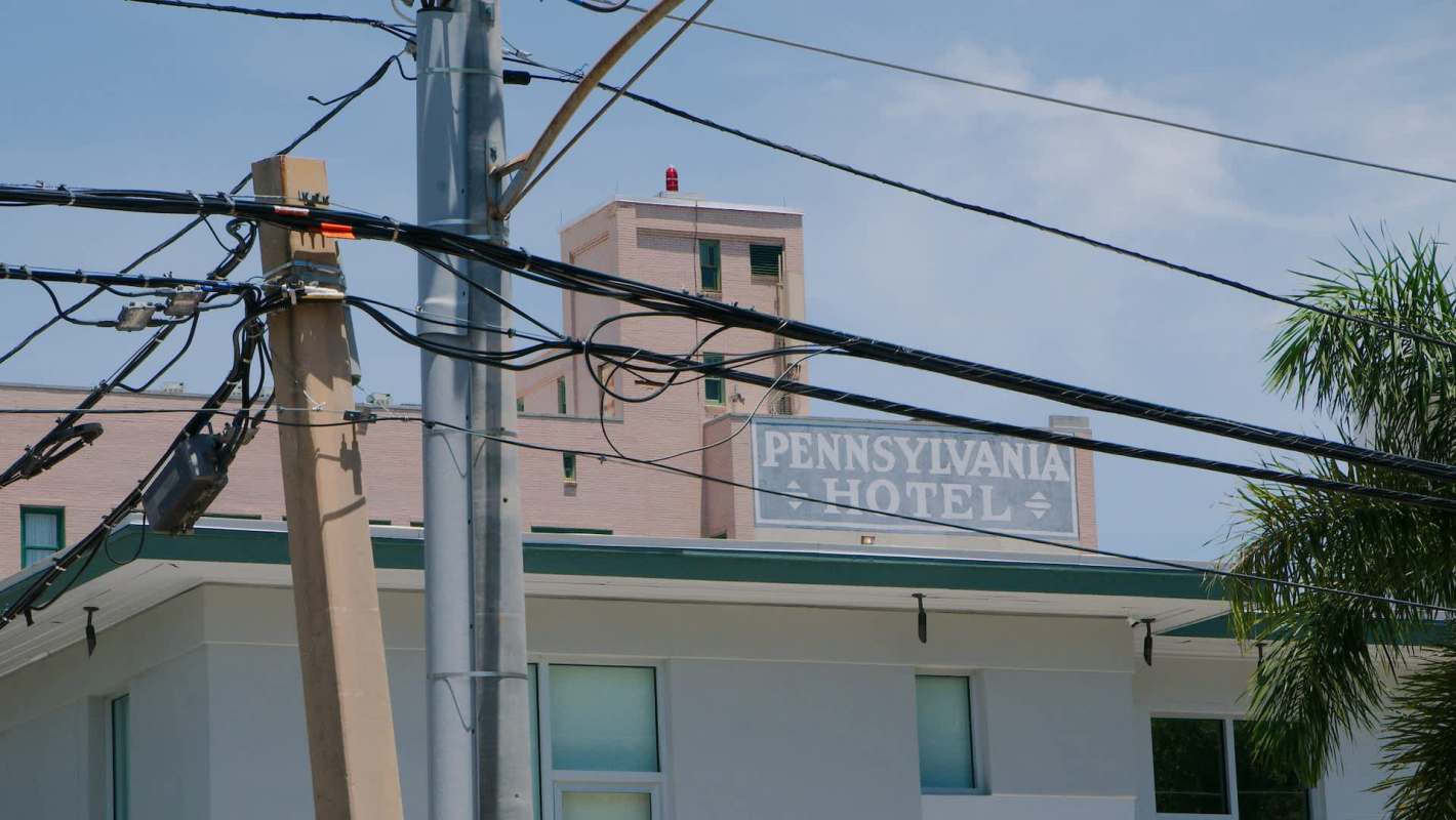 A hotel building with the name "Pennsylvania Hotel" visible among utility poles and wires.