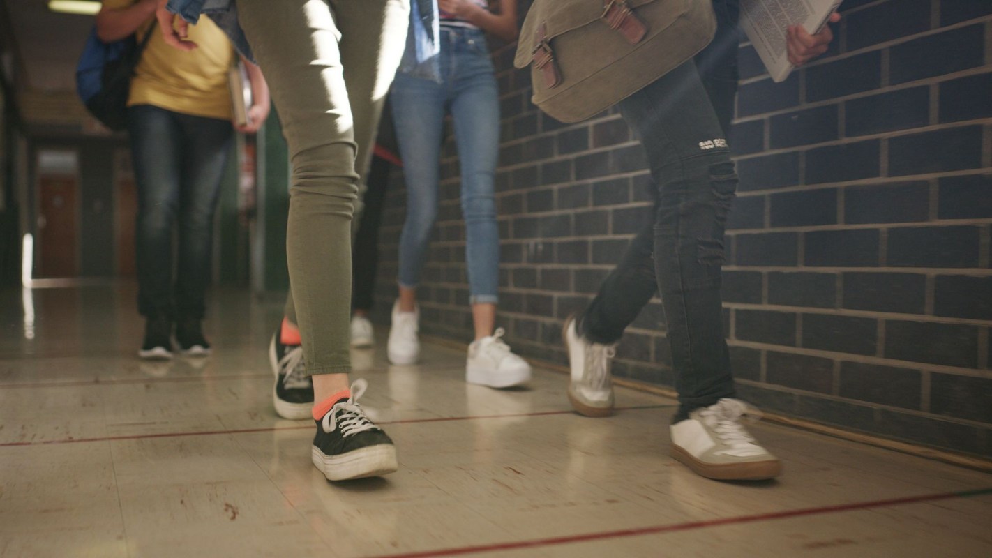 Students walking down a hallway.