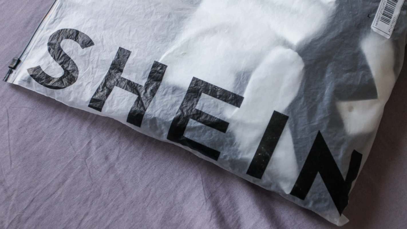 A package with the logo "SHEIN" on a textured surface.