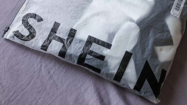 A package with the logo "SHEIN" on a textured surface.