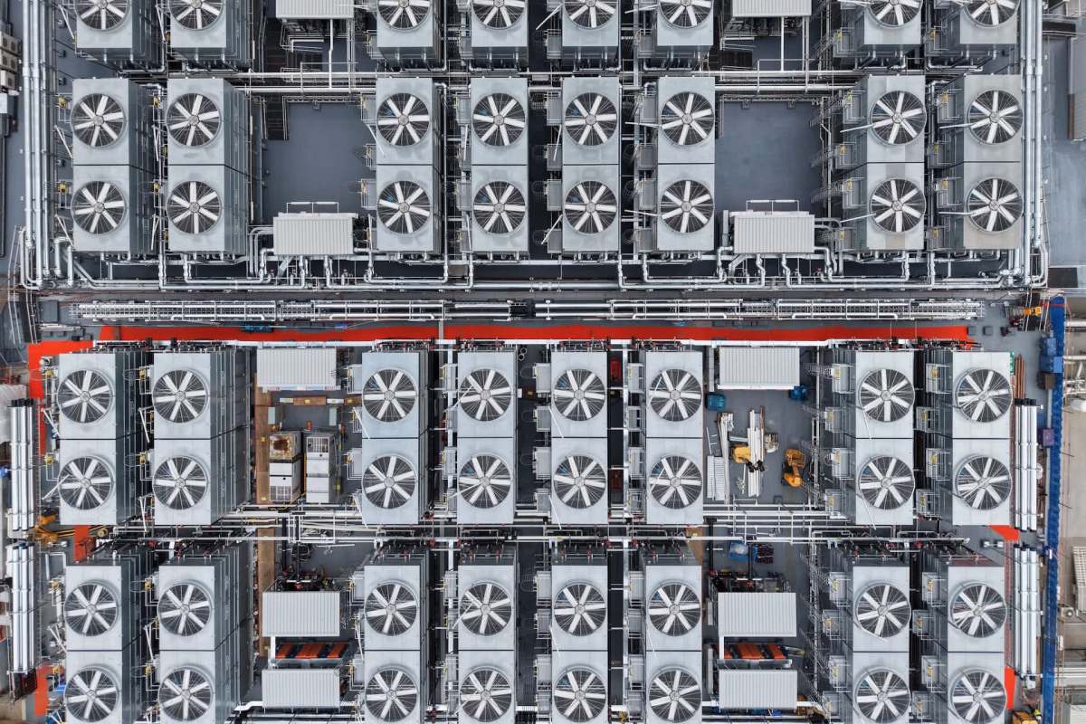 An overhead view of a large industrial facility featuring multiple fans and piping systems.