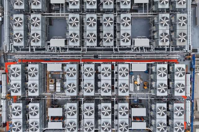 An overhead view of a large industrial facility featuring multiple fans and piping systems.