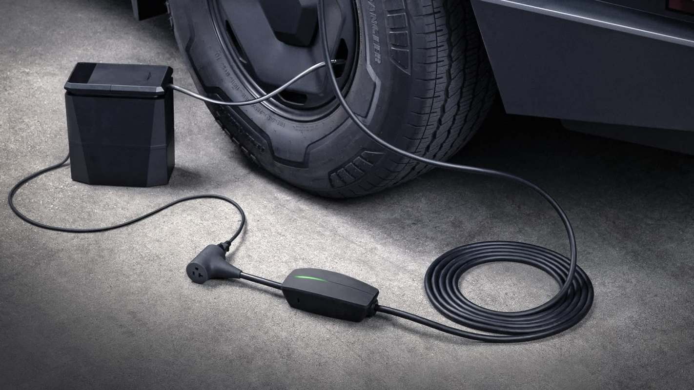 A Tesla Outlet Adapter connected to a Tesla vehicle.
