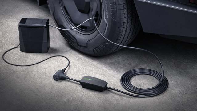 A Tesla Outlet Adapter connected to a Tesla vehicle.