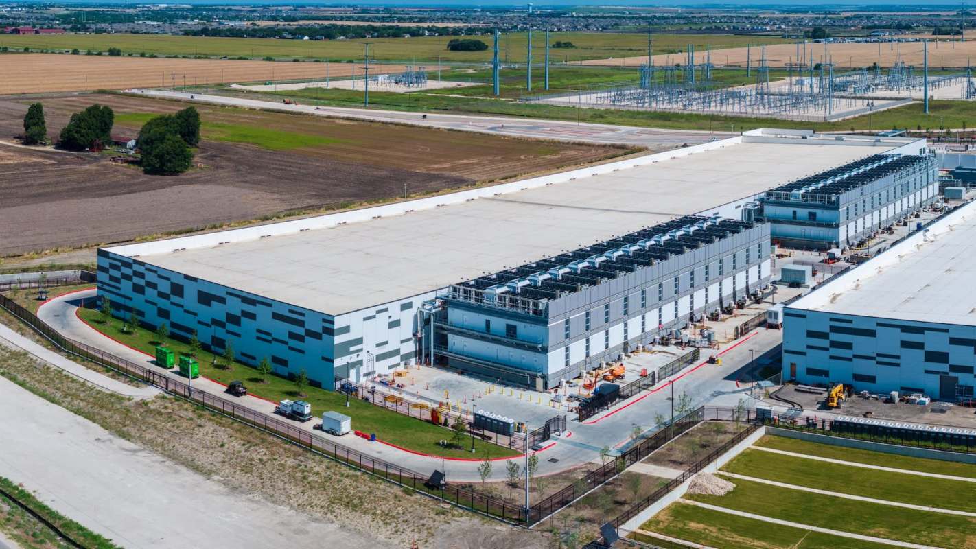 A large industrial building with multiple loading docks and surrounding green spaces.
