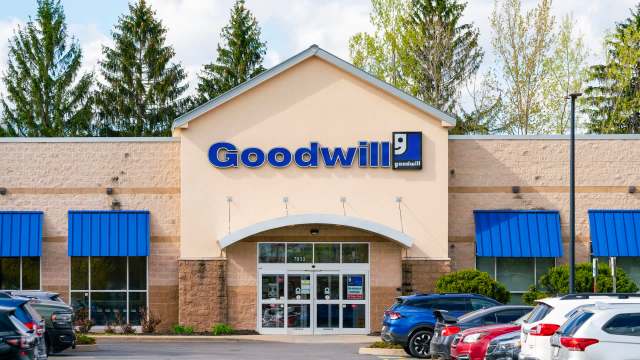 A Goodwill store with a blue awning and large glass entrance surrounded by parking.