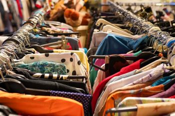 Racks of clothes at a thrift store.