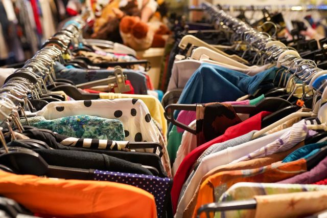 Racks of clothes at a thrift store.