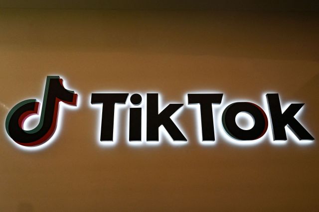 A TikTok logo on a wall.