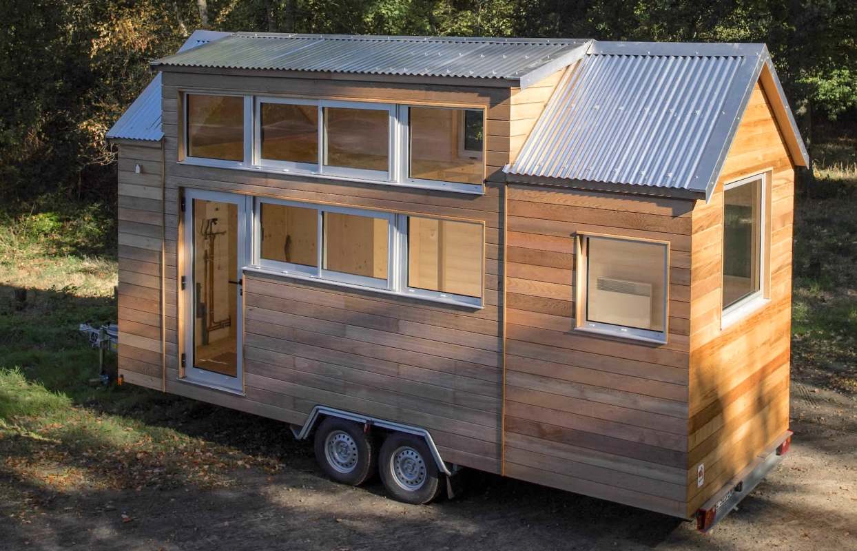 A wooden tiny house on wheels.