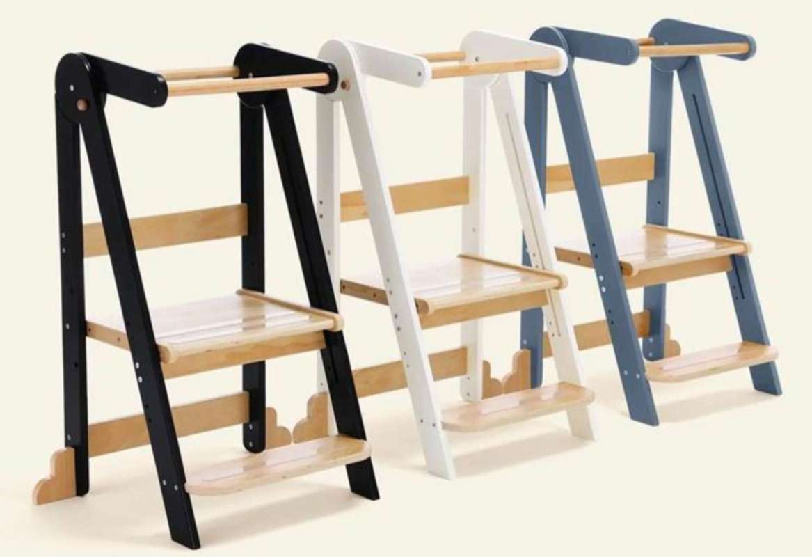 Three wooden step ladders in black, white, and blue, featuring a minimalist design and wooden steps.