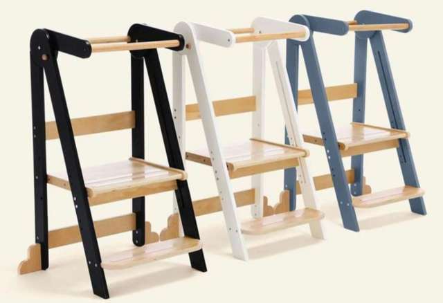 Three wooden step ladders in black, white, and blue, featuring a minimalist design and wooden steps.
