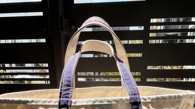The handles of an LL Bean tote bag.