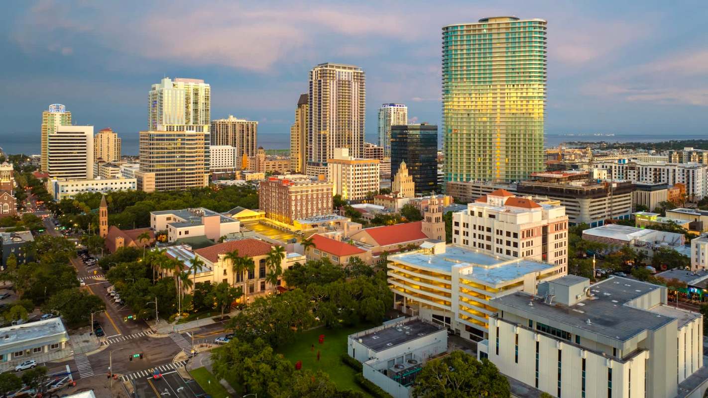 Aerial view of St. Petersburg, Florida, featuring modern skyscrapers, historic buildings, and green spaces.