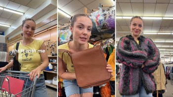 A woman shopping in a thrift store, showing off a purse and coat.