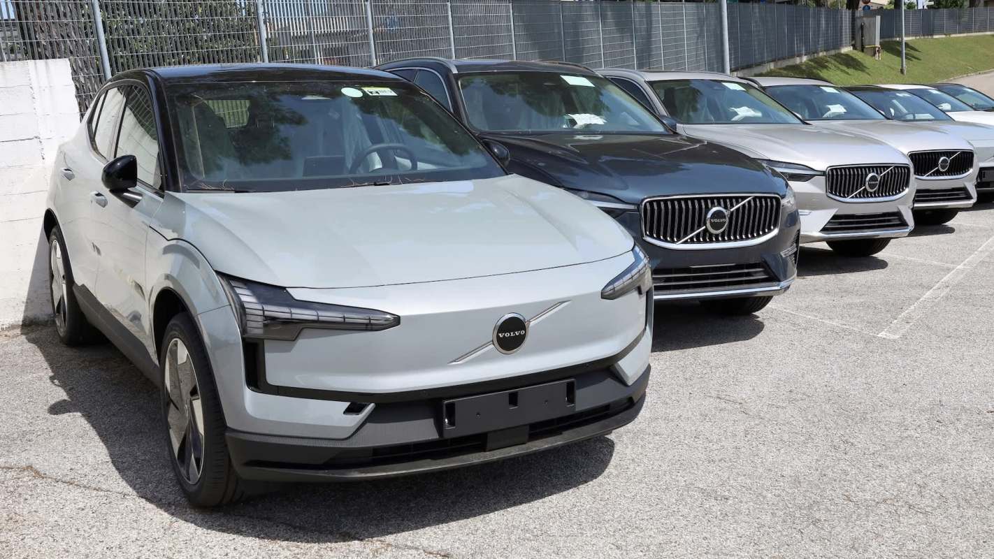 A row of various Volvo cars parked in an outdoor lot.
