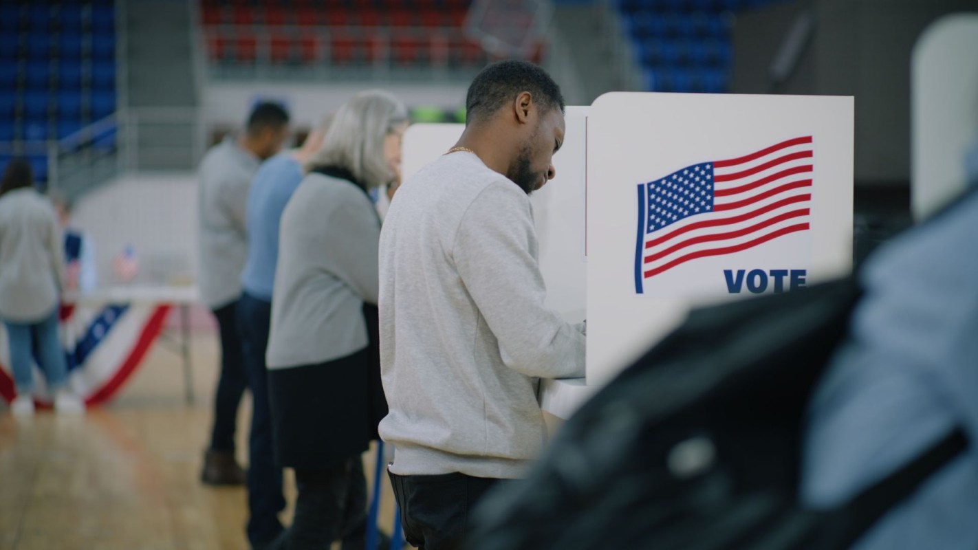 People casting votes at a polling place.