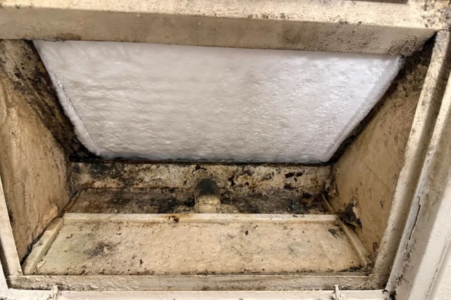 The inside of a wall AC unit.