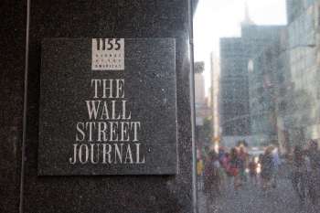 A sign for The Wall Street Journal located at 1155 Avenue of the Americas.