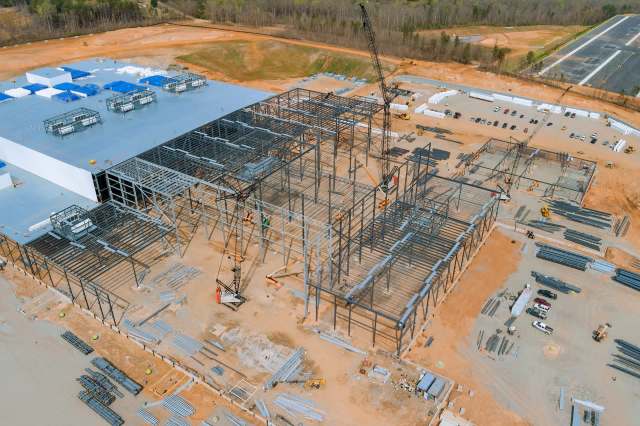 A construction site near a wooded area.