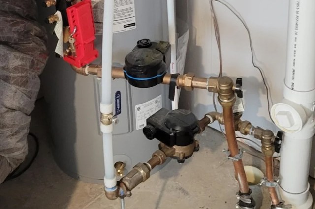 Plumbing components including valves and pipes connected to a water heater.