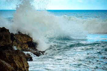 Waves crashing along a rocky coastline.