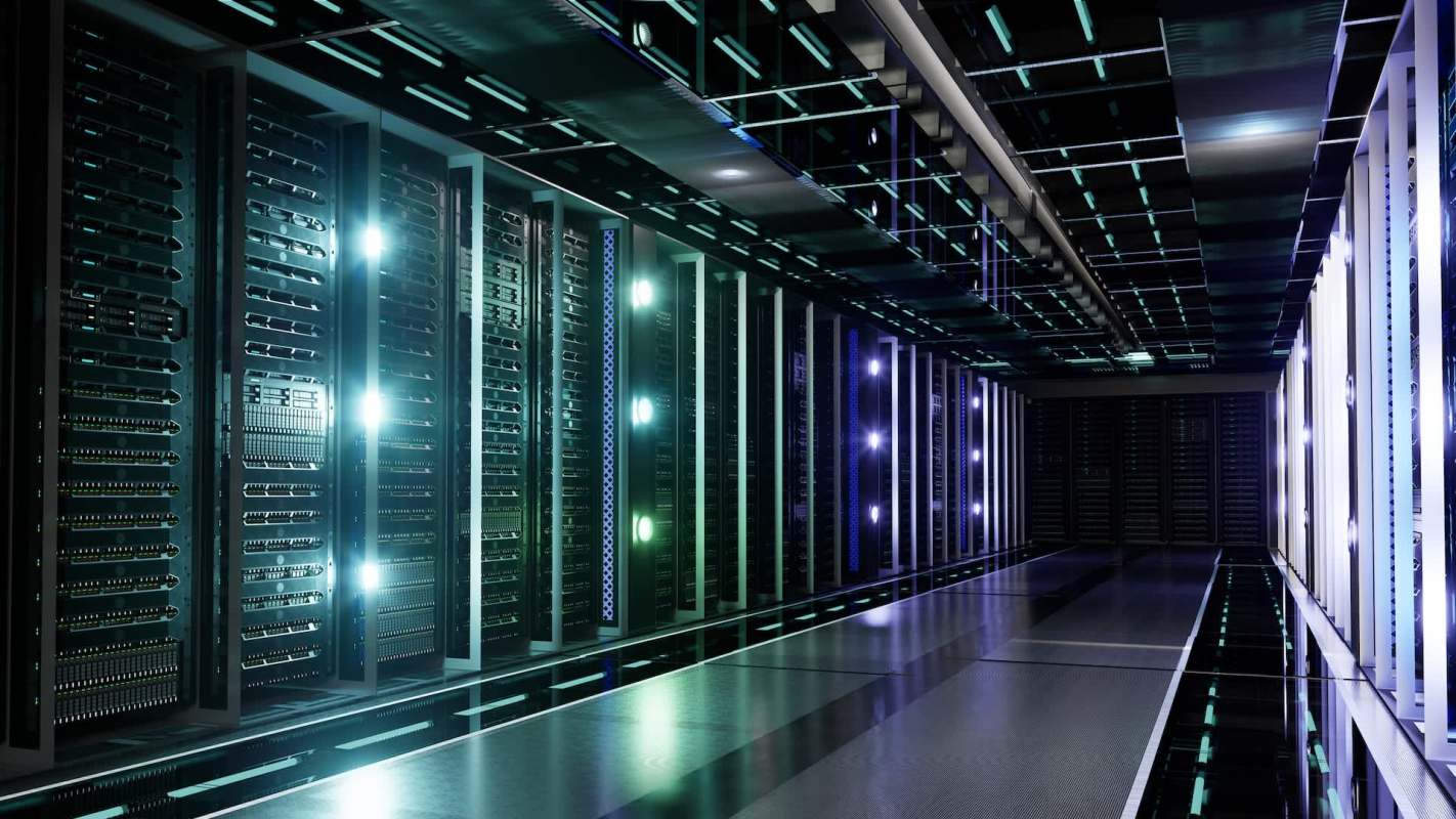 A server room filled with racks of computers and illuminated panels.