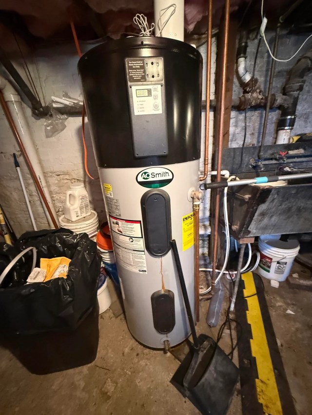 A water heater with a brown streak on the outer casing.