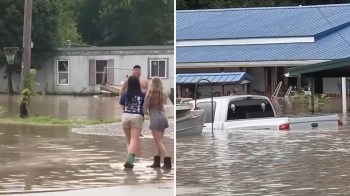 Buildings and a truck submerged in floodwaters.