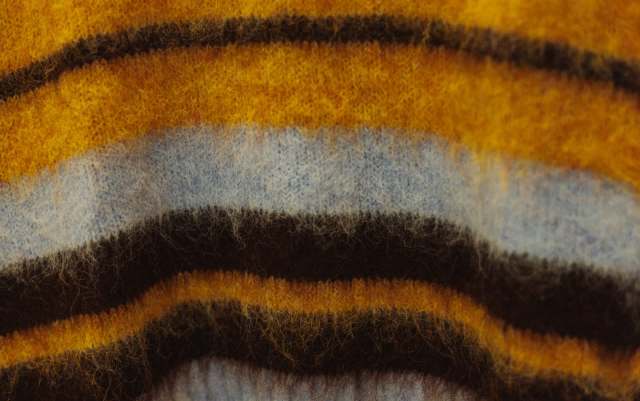 A fabric with horizontal stripes in yellow, blue, and brown.