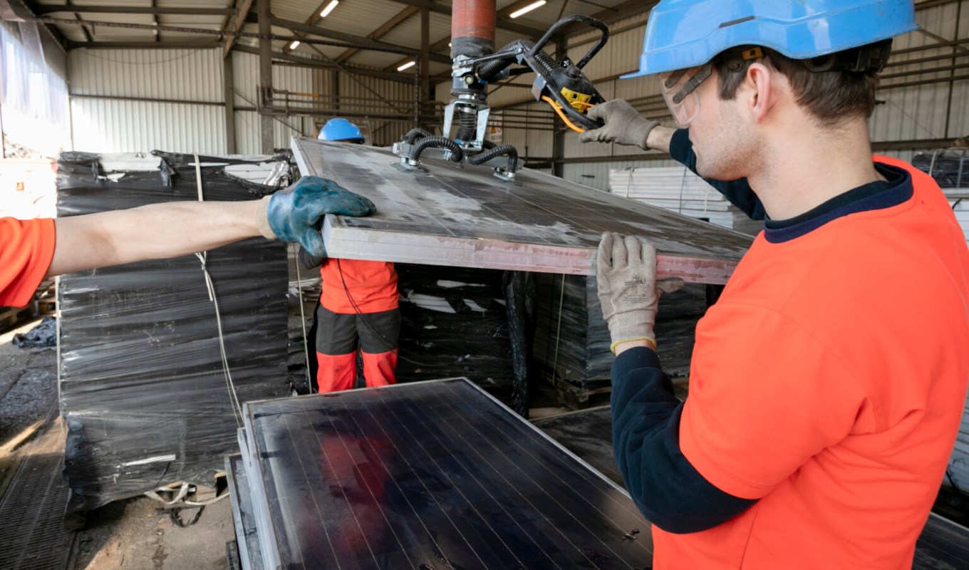 People handling solar panels.