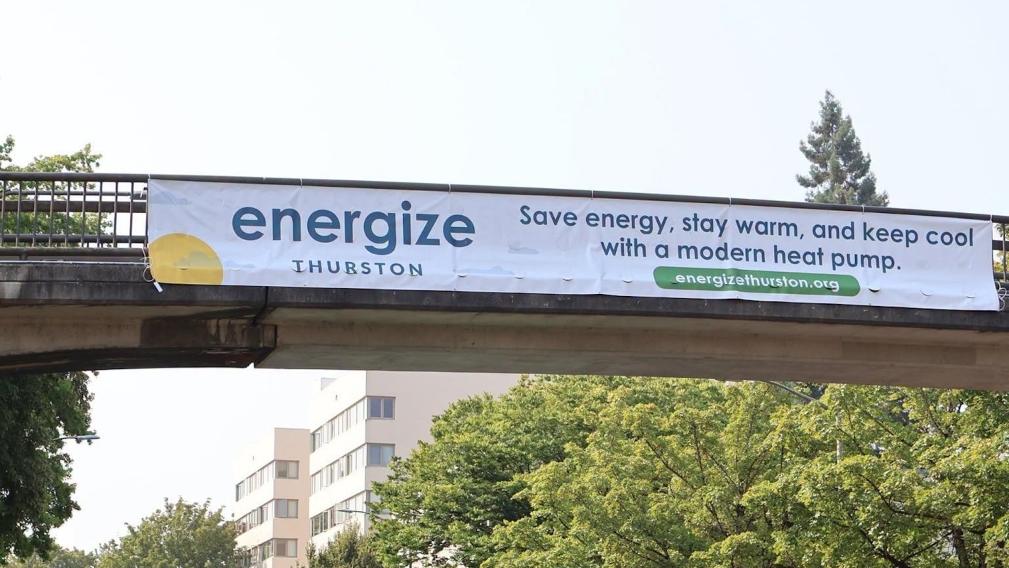 A banner promoting energy savings and modern heat pumps in Thurston, Washington.