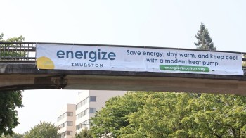 A banner promoting energy savings and modern heat pumps in Thurston, Washington.