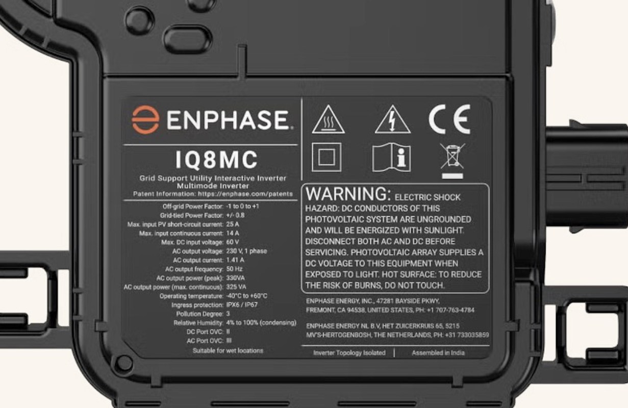 A close-up of the back panel of an Enphase IQ8MC inverter, displaying specifications and warning information.