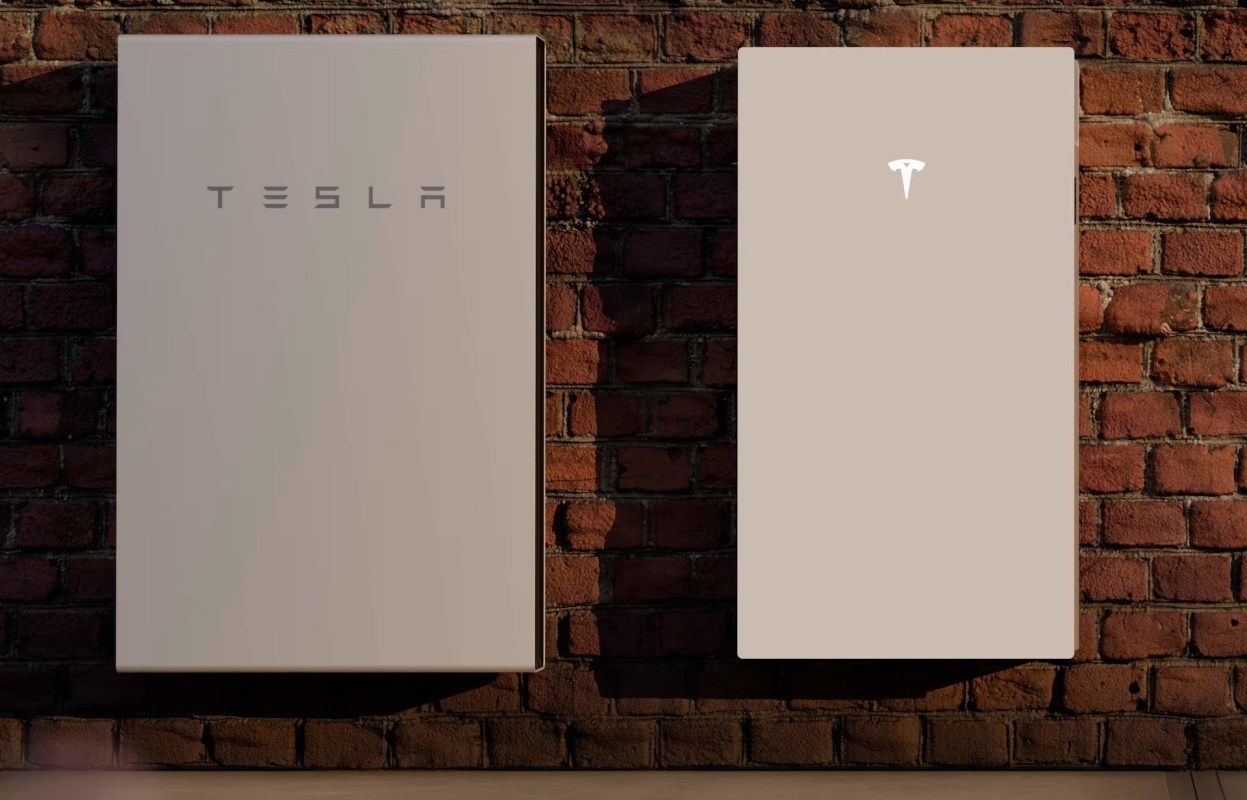 Two Tesla Powerwall storage units mounted on a brick wall.