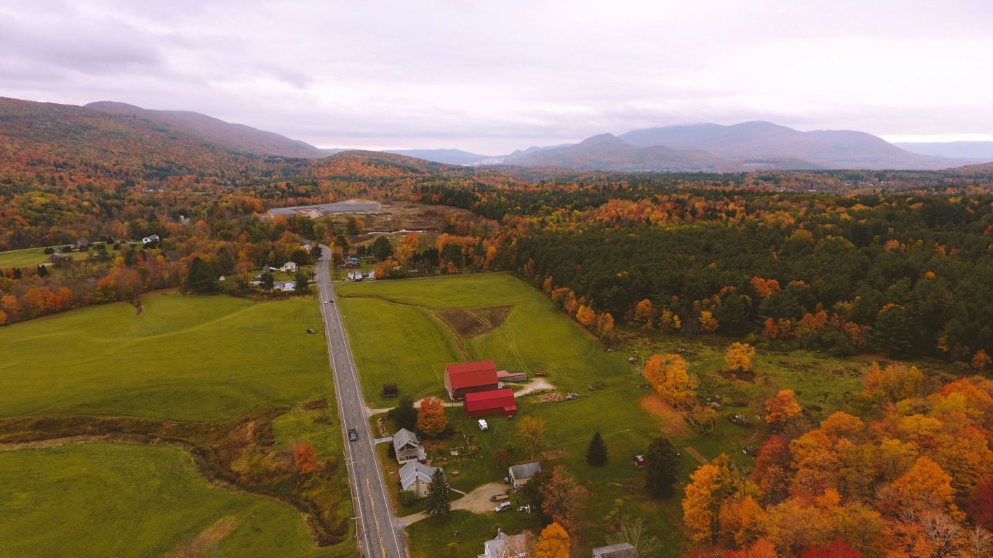 Aerial view of Clarksburg Massachusetts shows a winding road through autumn trees