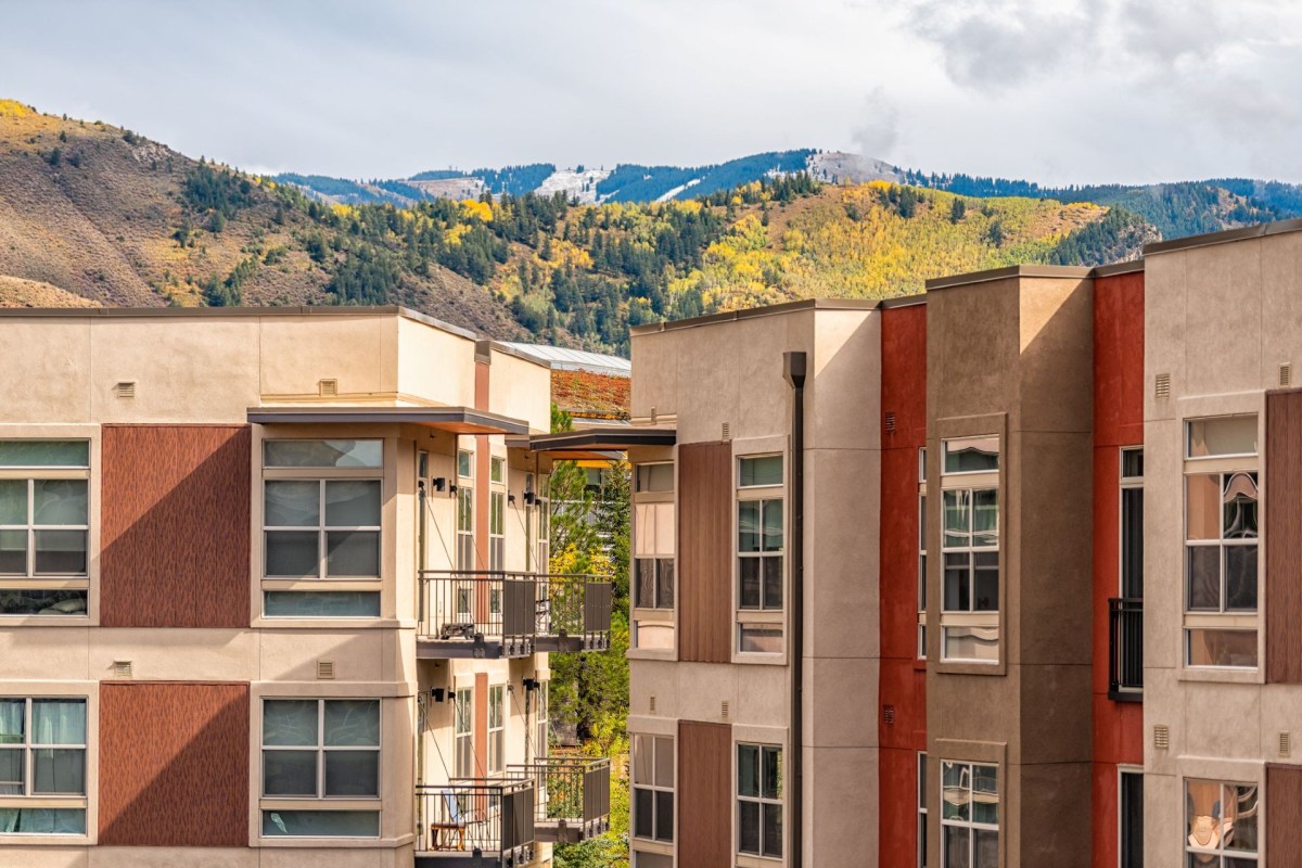 Multiple building condos against a background of Colorado mountains