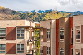 Multiple building condos against a background of Colorado mountains