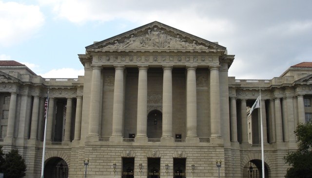 A large classical government building with columns and sculptures on the pediment.