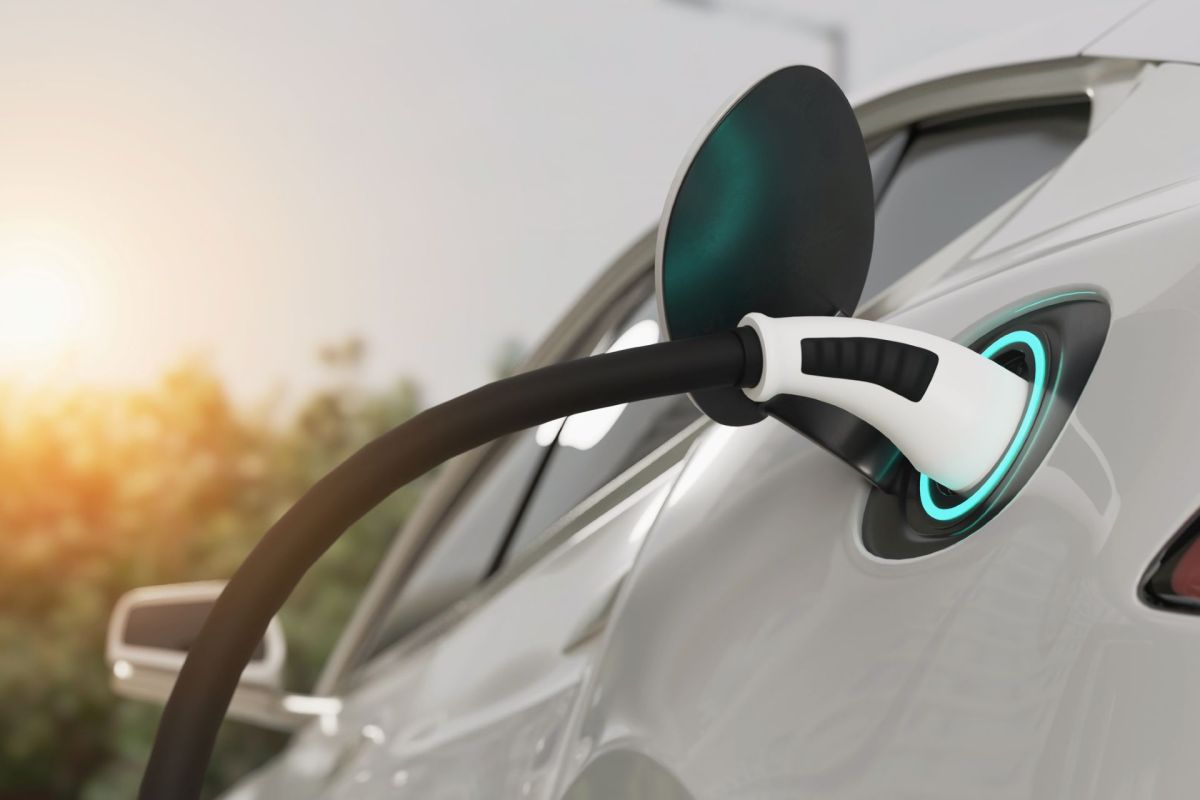 An electric vehicle is plugged in to charge