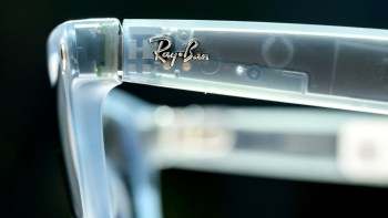 A close-up of a clear Meta glasses frame featuring the Ray-Ban logo.