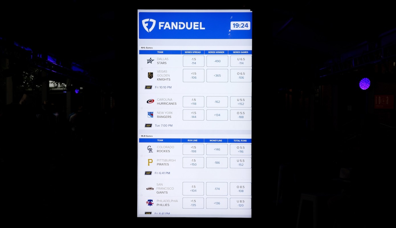 A FanDuel digital display board showing betting odds and game information for NHL and MLB games.