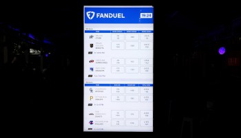 A FanDuel digital display board showing betting odds and game information for NHL and MLB games.
