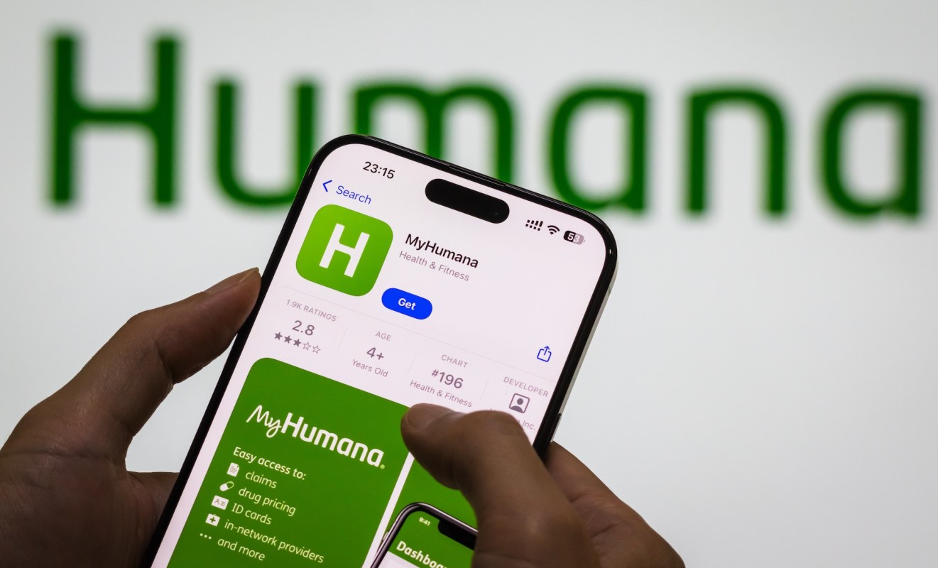 A person holds a smartphone displaying the MyHumana app against a green background with the text "Humana."