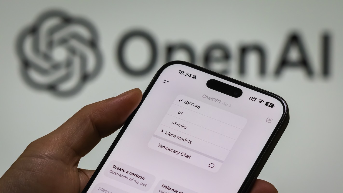 A hand holding a smartphone displaying the ChatGPT interface with different options, with the OpenAI logo in the background.