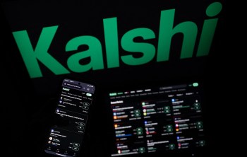 A smartphone displays a Kalshi app interface next to a laptop with a Kalshi trading dashboard.