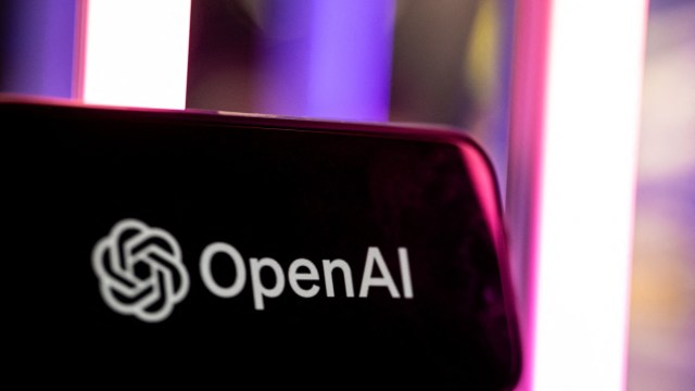 The OpenAI logo is displayed against a backdrop of colorful lights.