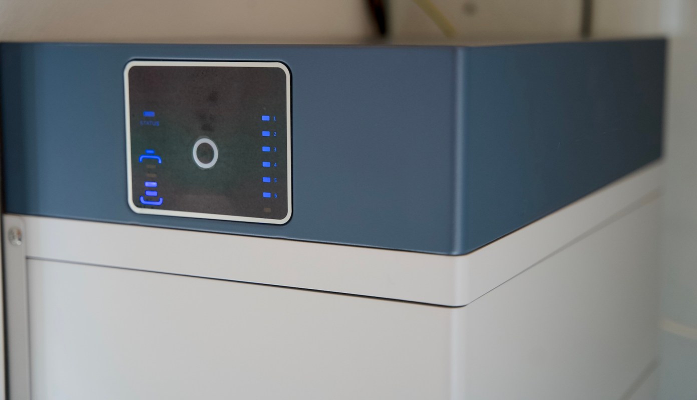 A machine with a digital display and indicator lights on a blue and white casing.