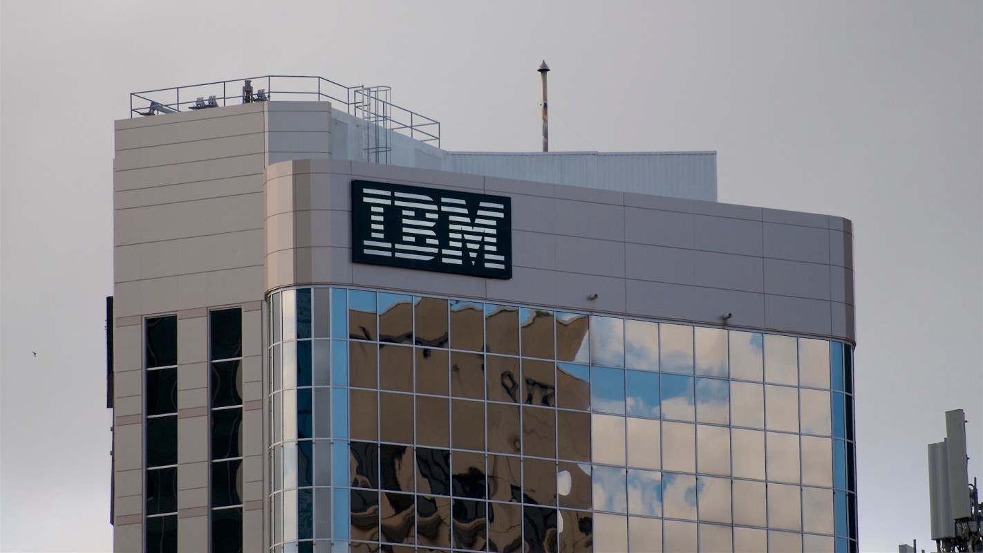 A building with the IBM logo on its side, featuring reflective glass windows.