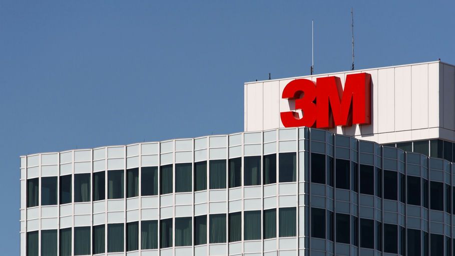 A corner of a building with a large red "3M" logo on top and glass windows below.